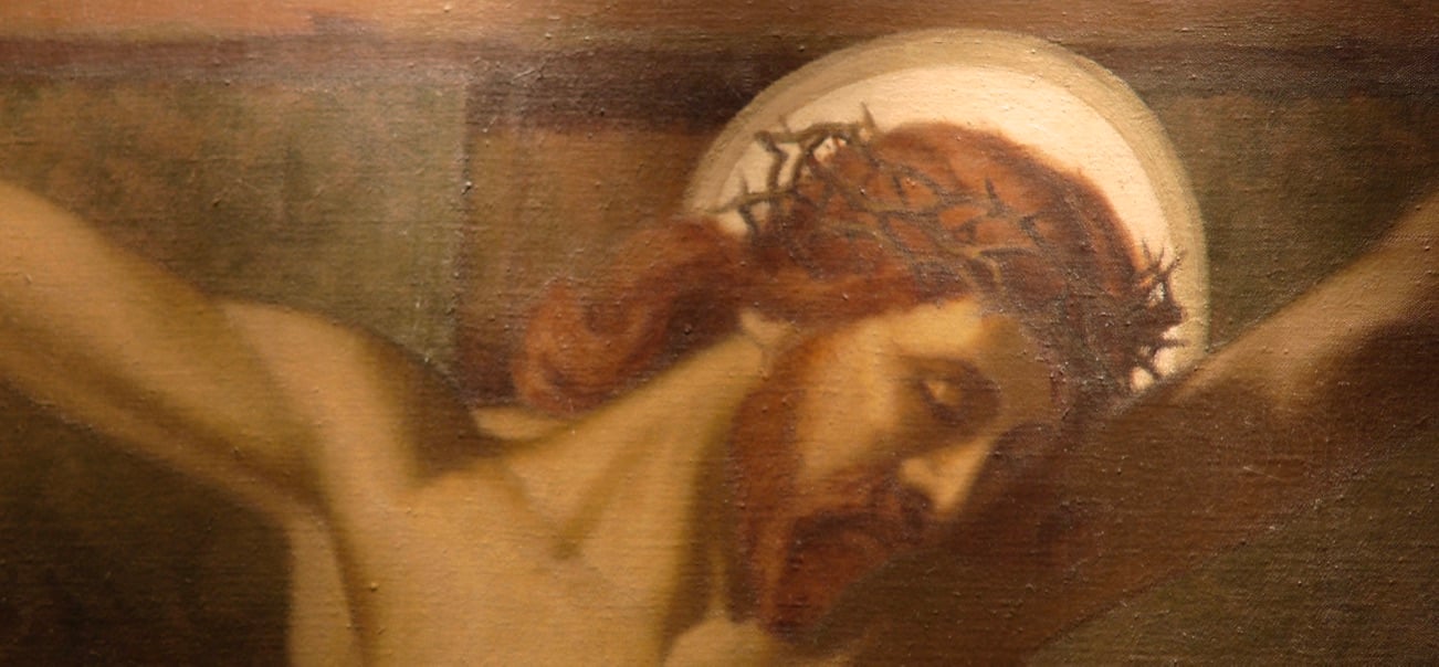 Closeup image of Christ's face while on the Cross in painting in sanctuary